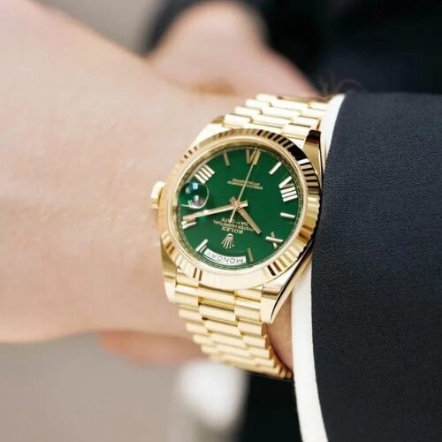 rolex oyster perpetual day date yellow gold with a green dial
